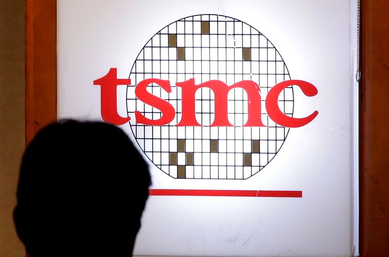 &copy; Reuters. FILE PHOTO: A man sits in front of the logo of Taiwan Semiconductor Manufacturing Co Ltd (TSMC) during an investors&apos; conference in Taipei
