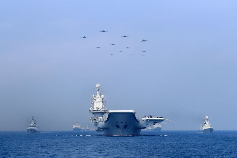 &copy; Reuters. Warships and fighter jets of Chinese People&apos;s Liberation Army (PLA) Navy take part in a military display in the South China Sea