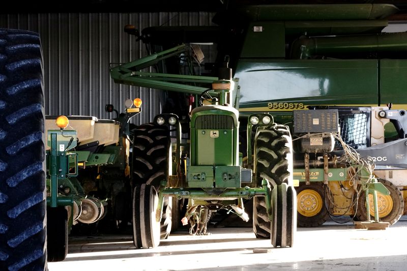 &copy; Reuters. FILE PHOTO: A John Deere tractor, a combine, and other heavy machinery sit inside a barn on a corn and soybean farm in Woodburn, Indiana