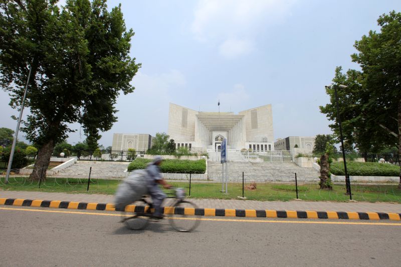 &copy; Reuters. A man rides a bicycle past the Supreme Court building in Islamabad