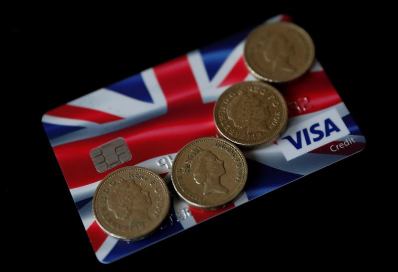 &copy; Reuters. British pound coins are seen on top of a Union Jack themed Visa credit card in this photo illustration taken in Manchester, Britain.