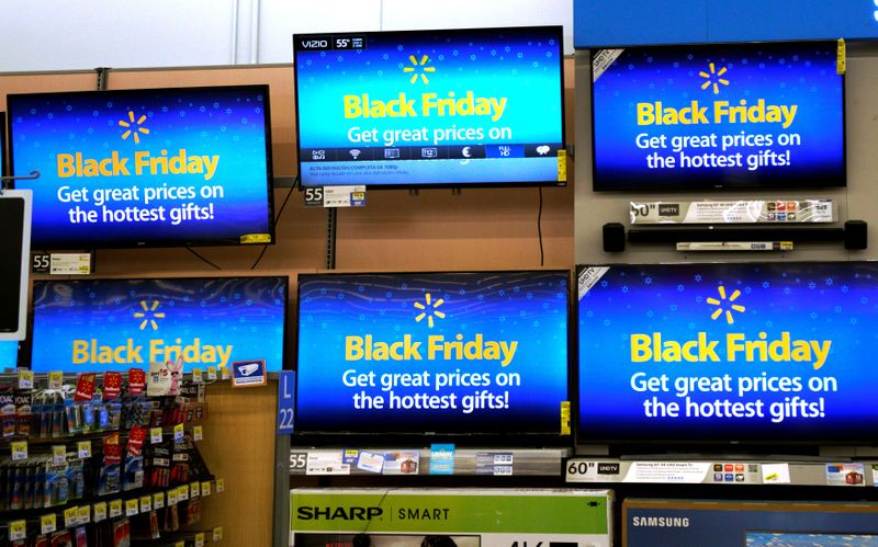 &copy; Reuters. FILE PHOTO: Advertisements of the upcoming Black Friday sales are seen on TV screens at a Walmart store in Westminster