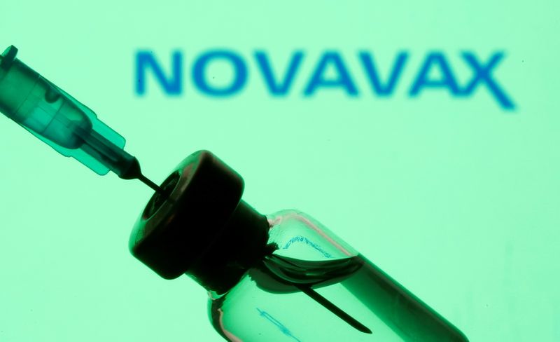 &copy; Reuters. Vial and sryinge are seen in front of displayed Novavax logo in this illustration taken