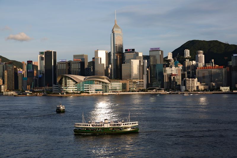 © Reuters. FILE PHOTO: A Star Ferry boat crosses Victoria Harbour in front of a skyline of buildings in Hong Kong