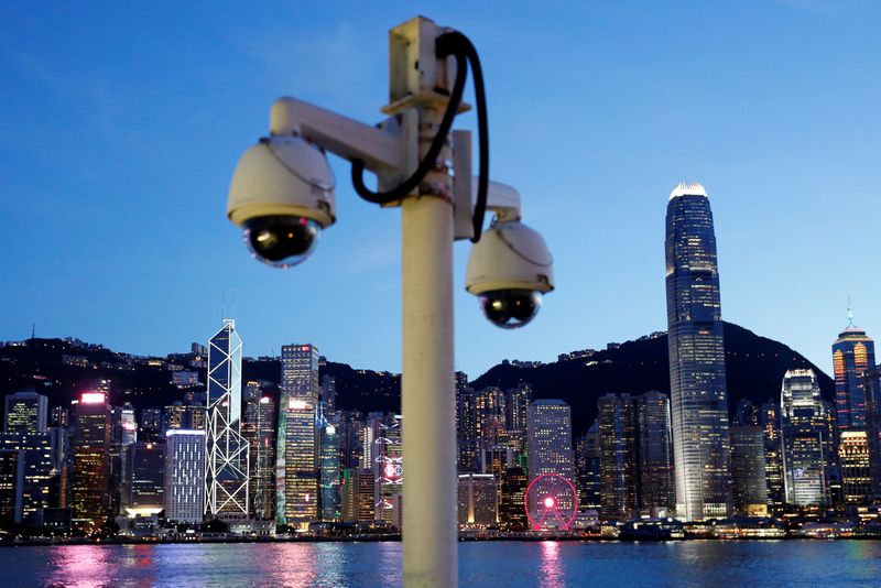 &copy; Reuters. Pair of surveillance cameras are seen along the Tsim Sha Tsui waterfront as skyline buildings stand across Victoria Harbor in Hong Kong