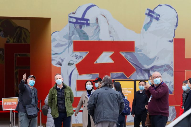 &copy; Reuters. WHO team members visit an exhibition on how China fought the coronavirus in Wuhan