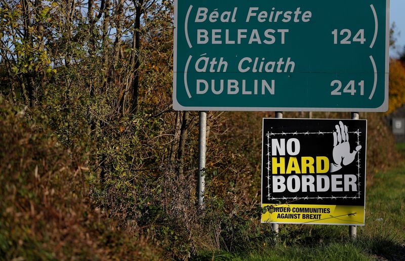 &copy; Reuters. FILE PHOTO: A &apos;No Hard Border&apos; poster is seen below a road sign on the Irish side of the border between Ireland and Northern Ireland near Bridgend