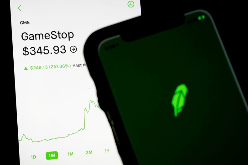 &copy; Reuters. FILE PHOTO: Trading information for GameStop is displayed on the Robinhood App as another screen displays the Robinhood logo