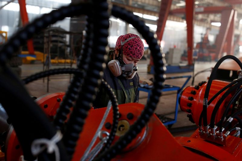 &copy; Reuters. A woman works in the Tianye Tolian Heavy Industry Co. factory in Qinhuangdao