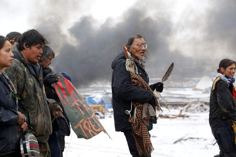 © Reuters. FILE PHOTO: Nathan Phillips marches with other protesters out of the main opposition camp against the Dakota Access oil pipeline near Cannon Ball