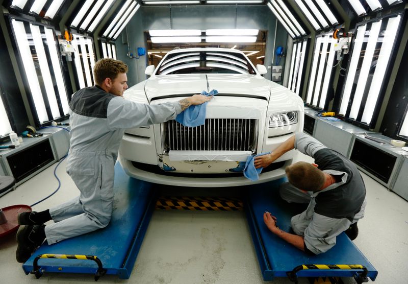 &copy; Reuters. Employees give a Rolls Royce Ghost its final finish polish at factory in Goodwood