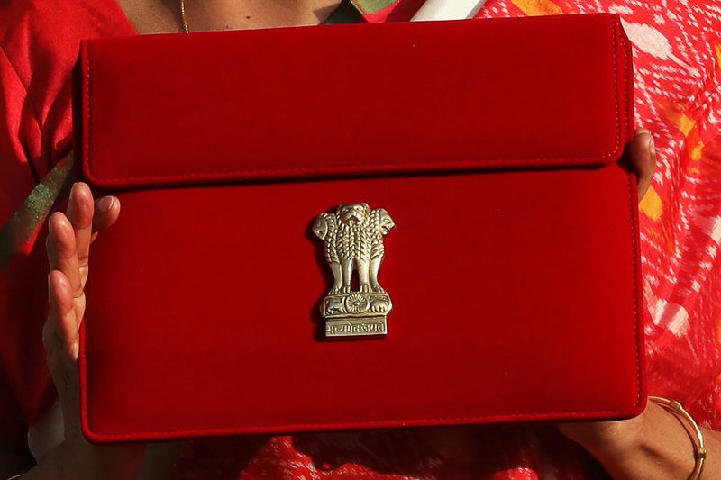 © Reuters. FILE PHOTO: India's Finance Minister Nirmala Sitharaman holds up a folder with the Government of India logo, as she leaves her office to present the federal budget in the parliament in New Delhi