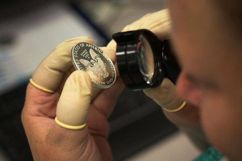 &copy; Reuters. FILE PHOTO: A quality control agent examines a silver eagle silver coin at the United States West Point Mint facility in West Point, New York
