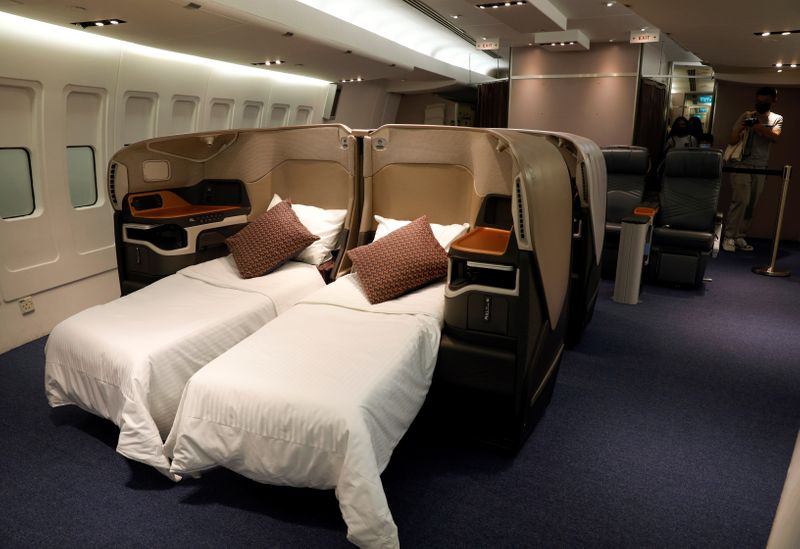 &copy; Reuters. People take photos of a business class cabin replica during a guided tour at the Singapore Airlines Training Centre in Singapore