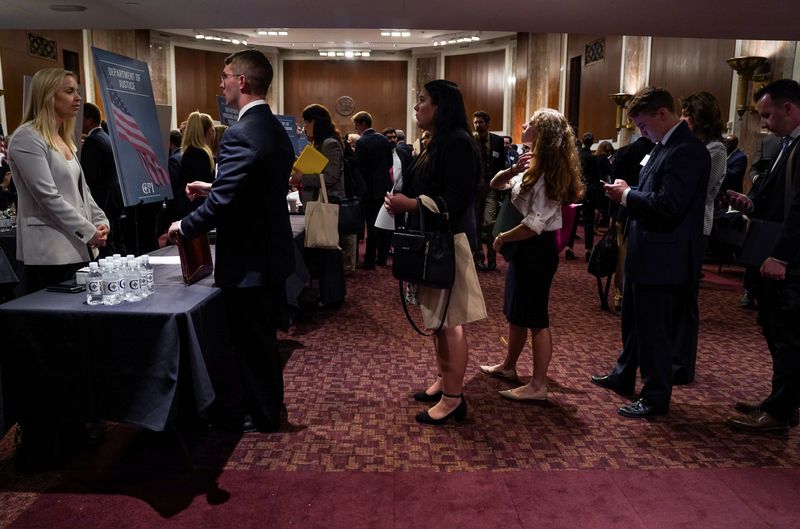 &copy; Reuters. People wait in line at a stand during the Executive Branch Job Fair hosted by the Conservative Partnership Institute at the Dirksen Senate Office Building in Washington