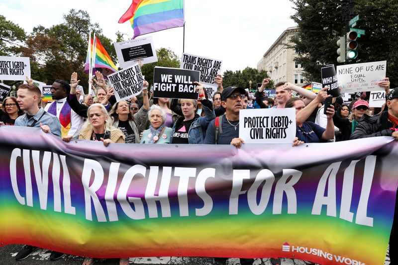 &copy; Reuters. FILE PHOTO: LGBTQ activists and supporters block the street outside the U.S. Supreme Court as it hears arguments in a major LGBT rights case in Washington