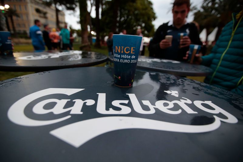 &copy; Reuters. A fan holds Carlsberg beer in the fan zone to watch EURO 2016 match in Nice
