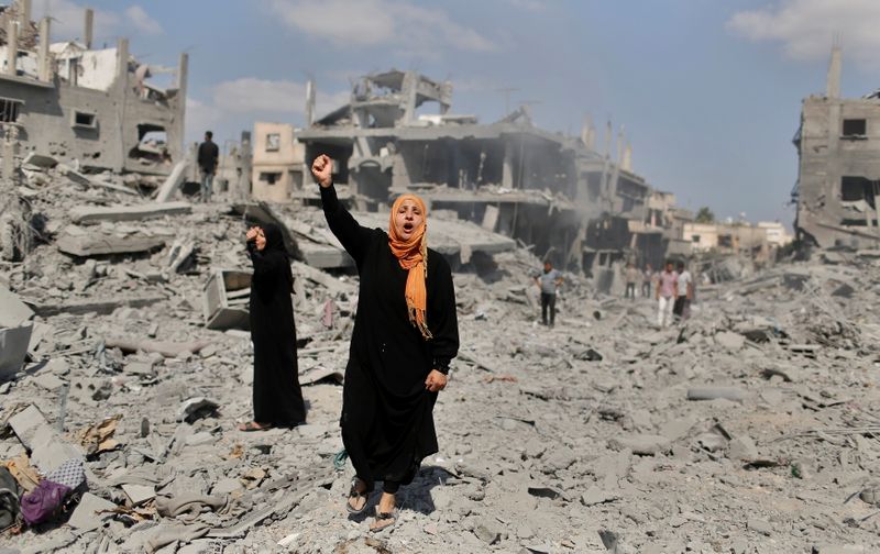 &copy; Reuters. Imagen de archivo de una mujer palestina gritando lemas en apoyo de los combatientes palestinos mientras está de pie junto a su casa destruida en el pueblo de Bait Hanun, luego de presenciar un fuerte ataque de artillería y fuerzas aéras israelíes dur