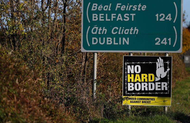 &copy; Reuters. A &apos;No hard Border&apos; poster is seen below a road sign on the Irish side of the border between Ireland and Northern Ireland near Bridgend