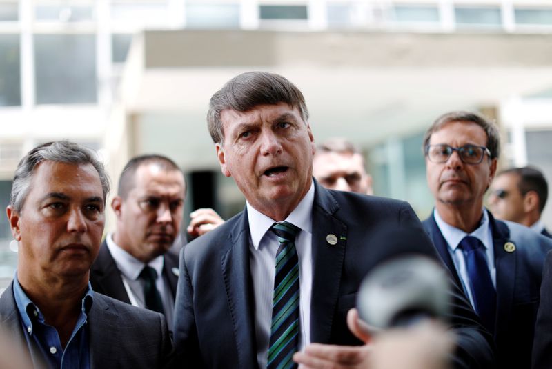 &copy; Reuters. FILE PHOTO: Brazil&apos;s President Bolsonaro talks with journalists after a meeting with Economy Minister Guedes in Brasilia