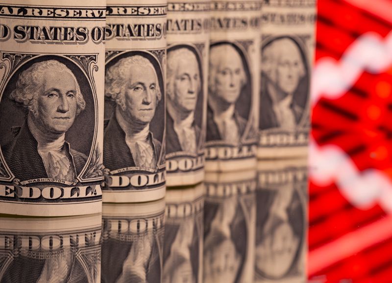 &copy; Reuters. U.S. one dollar banknotes are seen in front of displayed stock graph