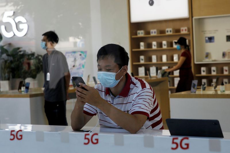 &copy; Reuters. Man checks a mobile phone inside a Huawei store at a shopping mall in Beijing