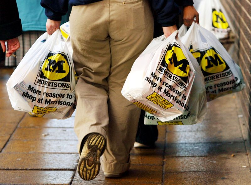 &copy; Reuters. FILE PHOTO: A shopper leaves with her groceries at the Morrisons supermarket in Bradford City center