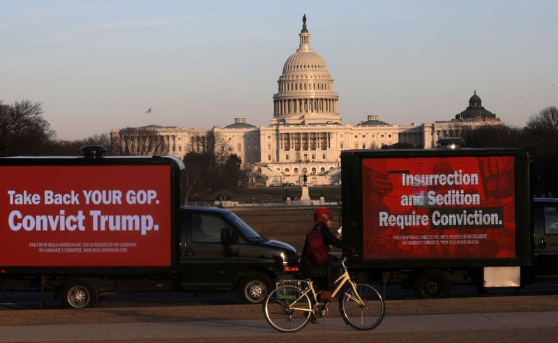 &copy; Reuters. Trucks advertising in support of convicting former U.S President Donald Trump in his upcoming second impeachment trial are seen parked on the National Mall with the U.S. Capitol Building visible behind them in Washington