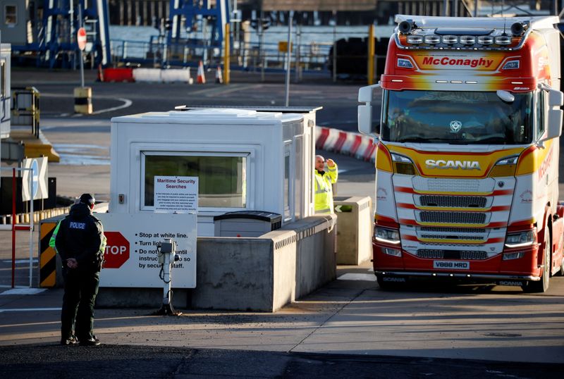 &copy; Reuters. FILE PHOTO: Police officers stand by port security at the entrance to the Port of Larne