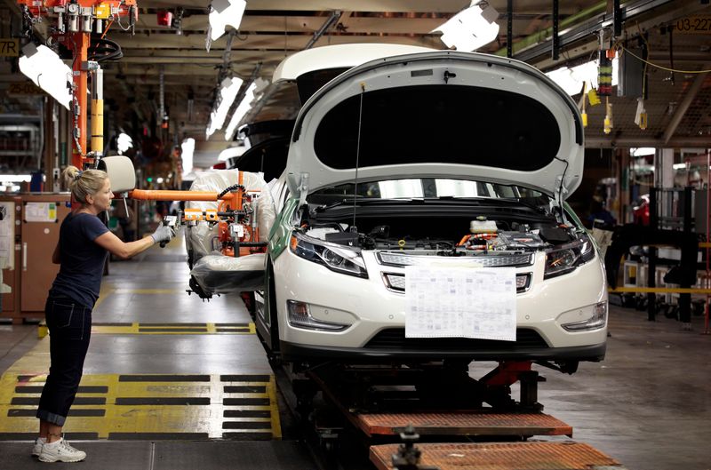 &copy; Reuters. United Auto Workers union member Carrie Attwood uses an ergonomic-arm to install a front seat in a Chevrolet Volt electric vehicle at General Motors Detroit-Hamtramck assembly plant in Hamtramck