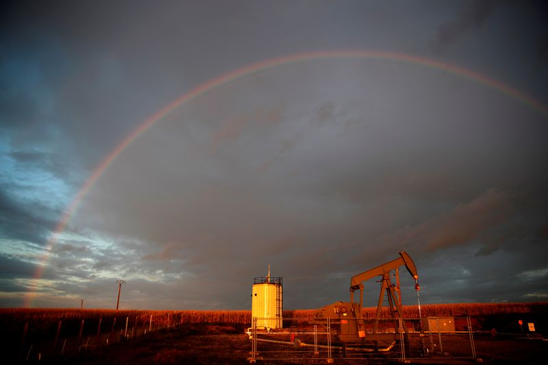 &copy; Reuters. A rainbow is seen over a pumpjack during sunset outside Scheibenhard