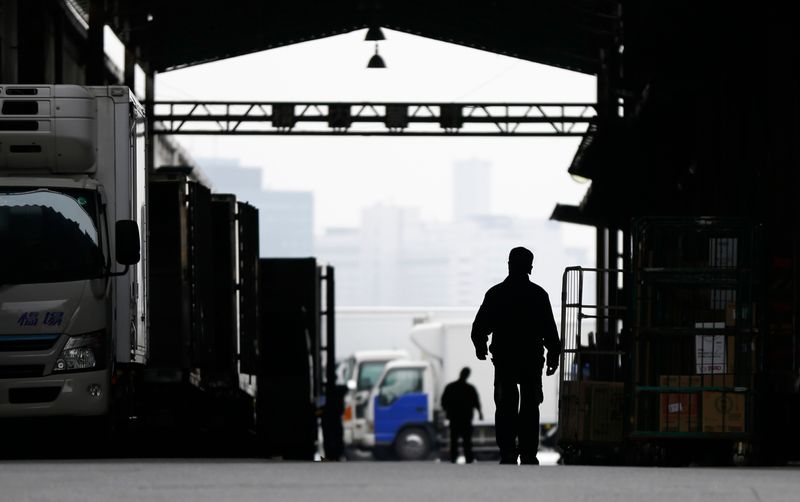 &copy; Reuters. FILE PHOTO: A worker walks at an industrial zone in Urayasu