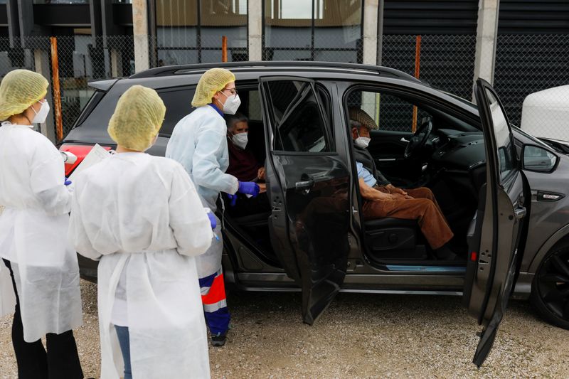 &copy; Reuters. FOTO DE ARCHIVO: Una pareja de ancianos se sienta en un coche tras recibir la primera dosis de la vacuna de Pfizer-BioNTech contra COVID-19 en Ronda, España