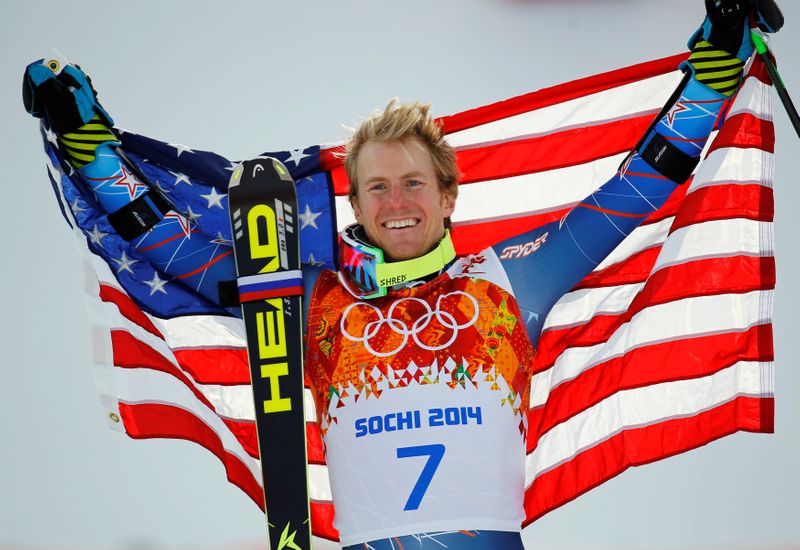 &copy; Reuters. FILE PHOTO: Winner Ted Ligety of the U.S. holds up his national flag during the flower ceremony for the men&apos;s alpine skiing giant slalom event in the Sochi 2014 Winter Olympics at the Rosa Khutor Alpine Center