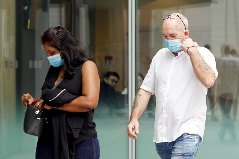 &copy; Reuters. Briton Skea Nigel and partner Agatha Maghesh Eyamalai arrive at the State Courts in Singapore
