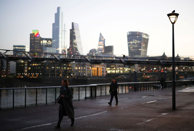 &copy; Reuters. The financial district can be seen as a people walk along the South bank, amid the coronavirus disease (COVID-19) outbreak, in London
