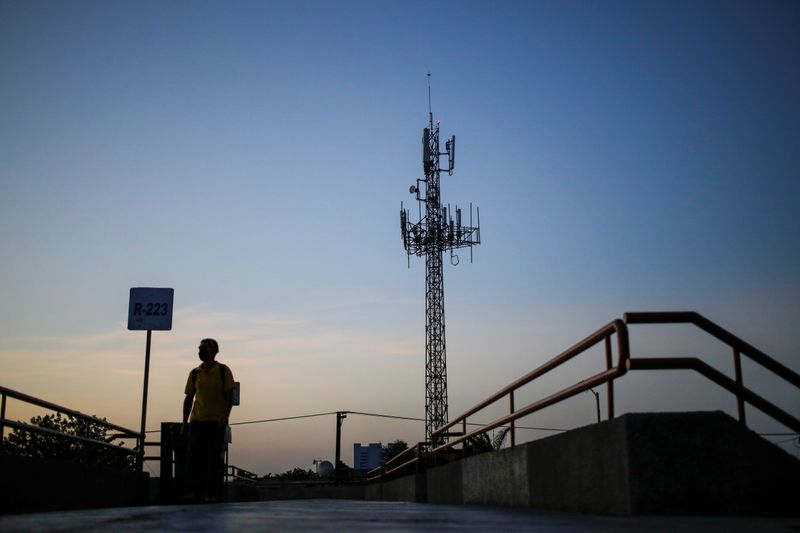 &copy; Reuters. A man walks by near a cellular tower in the municipality of Guadalupe