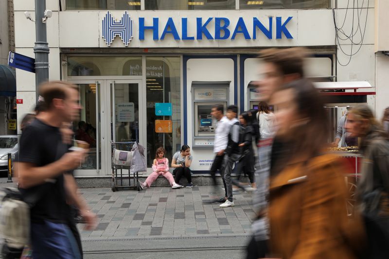 &copy; Reuters. People walk past by a branch of Halkbank in Istanbul