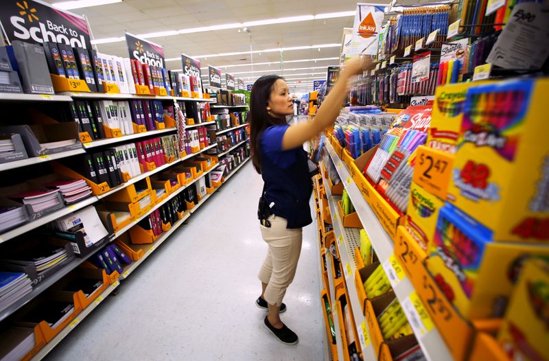 &copy; Reuters. Walmart department manager Karren Gomes helps stock shelves with school supplies as the retail store prepare for back to school shoppers in San Diego, California