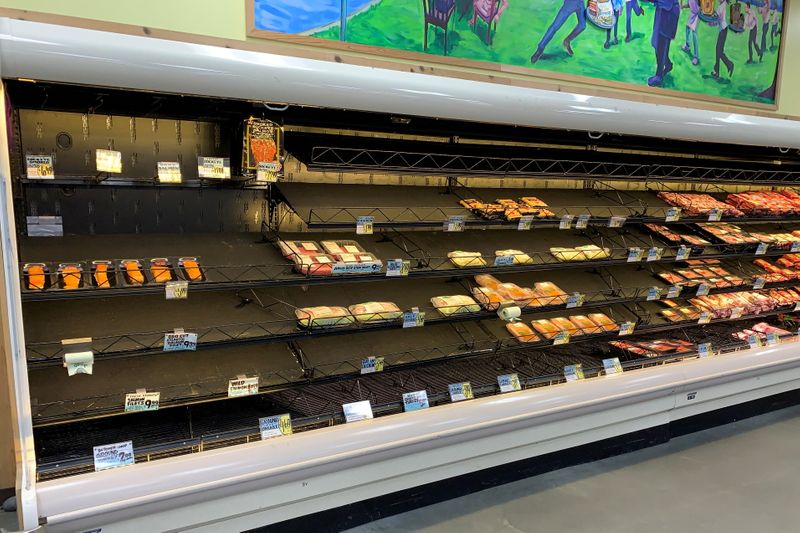 © Reuters. Empty meat shelves at a Trader Joe's supermarket, low on supplies due to inclement weather, is seen in Metairie