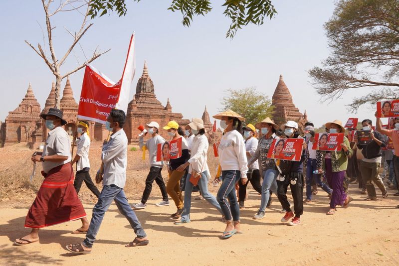 &copy; Reuters. Demonstrators march during a protest against the military coup, near temples in Bagan