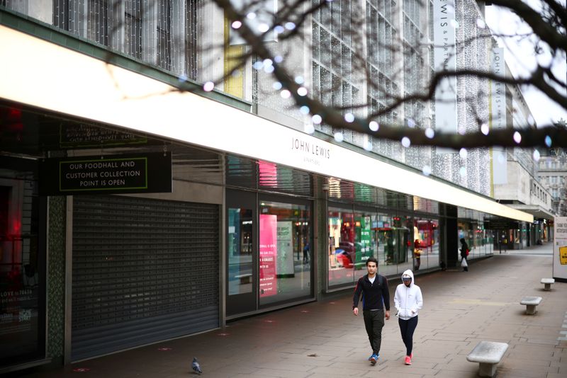 &copy; Reuters. FILE PHOTO: People walk along Oxford Street as shops remain closed under Tier 4 restrictions, amid the coronavirus disease (COVID-19) outbreak, in London