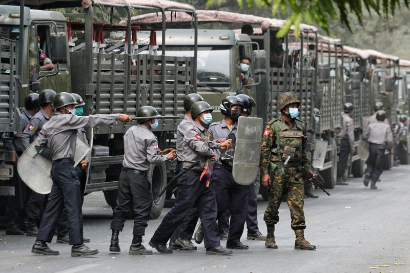 &copy; Reuters. Police and soldiers are seen during a protests against the military coup, in Mandalay
