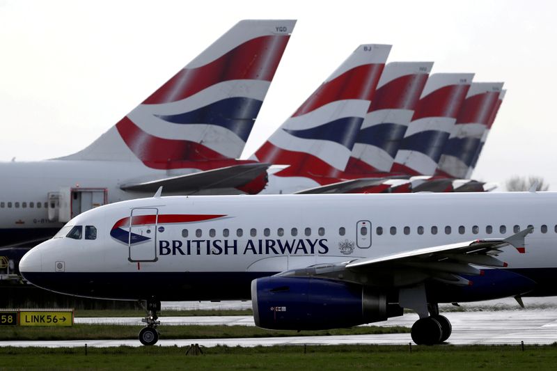 &copy; Reuters. FILE PHOTO: A British Airways plane taxis past tail fins of parked aircraft at Heathrow Airport in London