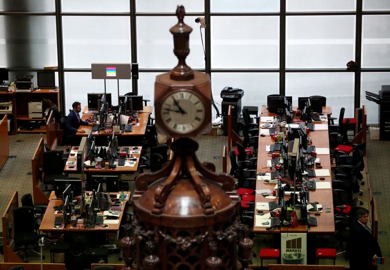 &copy; Reuters. FILE PHOTO: A man works at a desk in the Lloyd&apos;s of London building in the City of London financial district