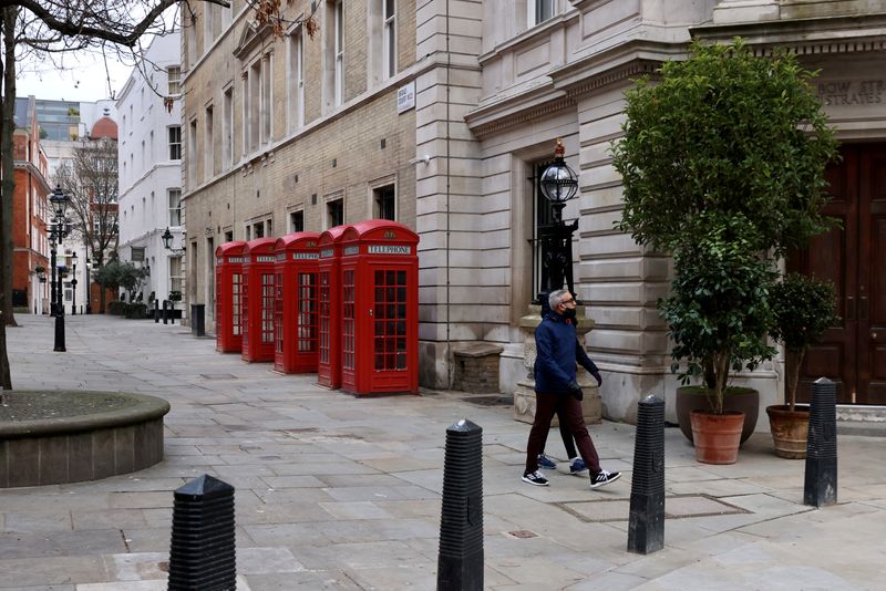 © Reuters. FILE PHOTO: People walk along a deserted street in London