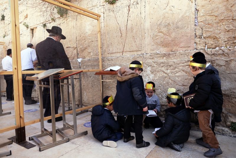 &copy; Reuters. Ultra-Orthodox Jewish boys play as men pray in front of the Western Wall, Judaism&apos;s holiest prayer site, in Jerusalem&apos;s Old City