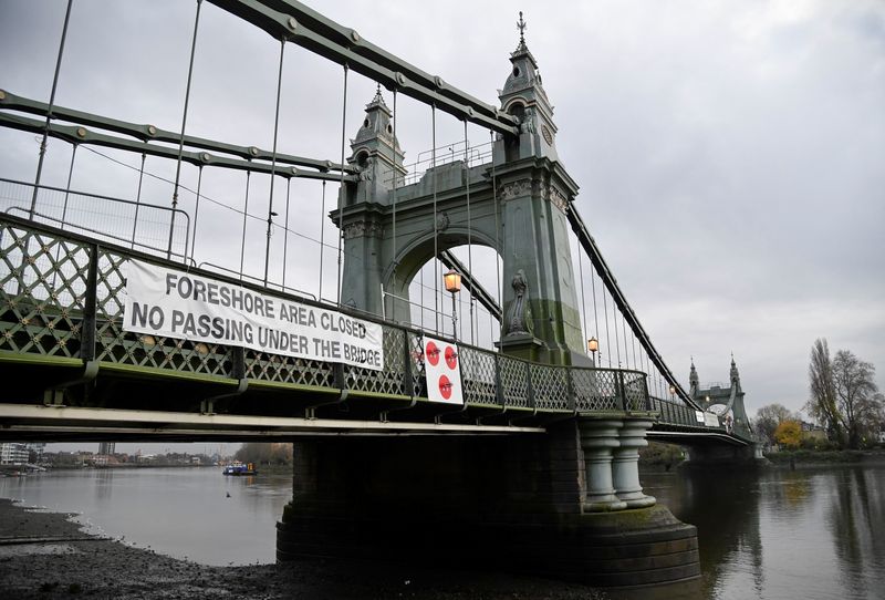 &copy; Reuters. A warning sign is seen attached to Hammersmith Bridge, the closure of which has caused the annual Oxford versus Cambridge boat race on the River Thames to be relocated, London, Britain