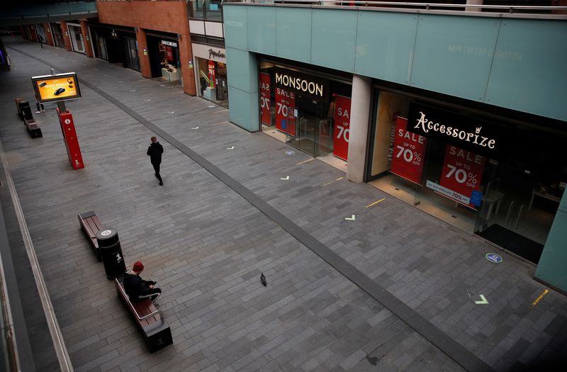 &copy; Reuters. A man walks along a deserted shopping street amid the outbreak of the coronavirus disease (COVID-19) in Liverpool