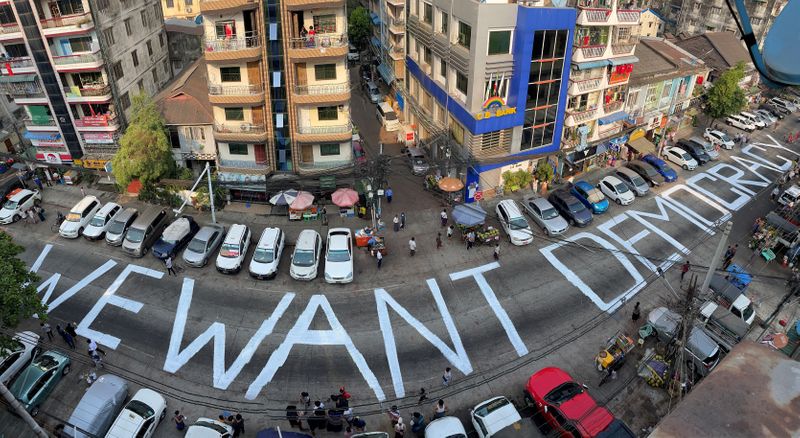 © Reuters. FILE PHOTO: A slogan is written on a street as a protest after the coup in Yangon
